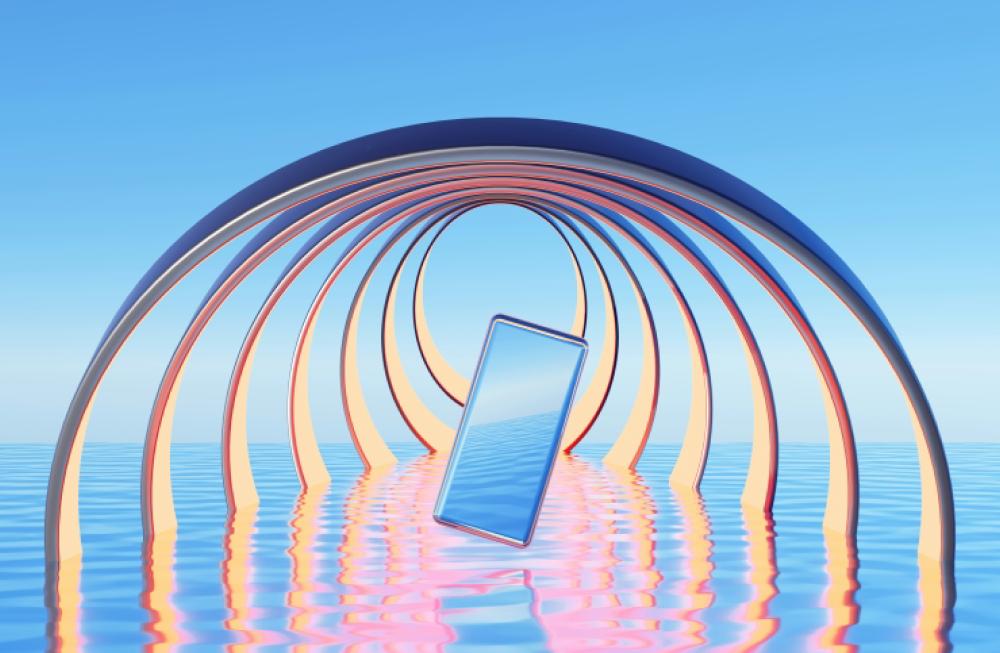 Phone floating in tunnel over reflective water